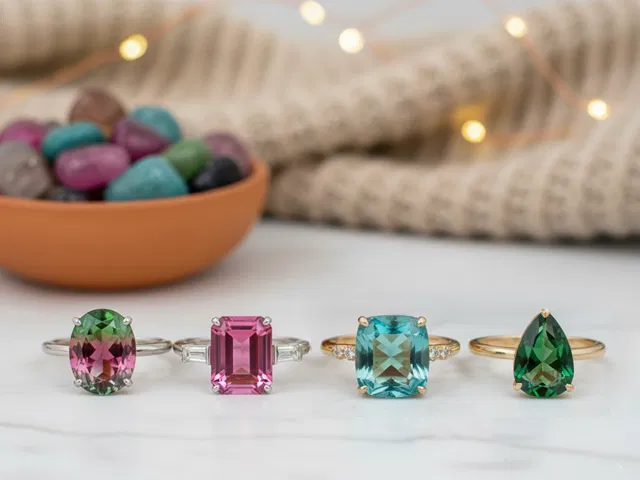 FOUR DIFFERENT COLOURED TOURMALINE RINGS